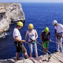 A group prepares to abseil down Malta&#039;s breathtaking coastal cliffs