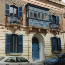 The facade of a fine house in Lija with window on either side of the front door. Photo,