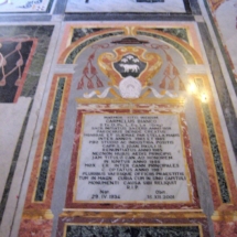 One of the many marble-inlaid floor tombstones