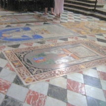 The marble-inlaid floor with tombstones carrying the coats of arms and inscriptions of the bishops of Mdina and other members of the cathedral chapter