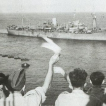 Port Chalmers arrives at Malta, cheered in its moorings by servicemen and civilians.